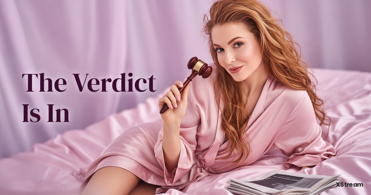 Redhead in a pink silk robe holding a gavel on satin sheets, adult industry news on German court keeping Pornhub online